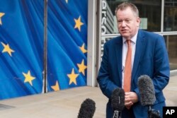 FILE - Then-Britain's chief Brexit negotiator David Frost gives a media statement at EU headquarters in Brussels, Belgium, Nov. 19, 2021.