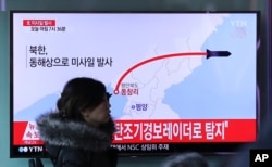 FILE - A television screen shows a news program reporting about North Korea's missile firing, at Seoul Train Station in Seoul, South Korea, March 6, 2017.