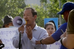 Rong Chhun, president of the Cambodian Confederation of Unions, uses a megaphone during a protest near the prime minister's residence in Phnom Penh on July 29, 2020. (Heng Sinith/AP)