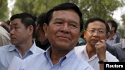 FILE - Kem Sokha, leader of the Cambodia National Rescue Party, arrives to visit fellow party members at the Prey Sar prison on the outskirts of Phnom Penh, Feb. 11, 2016. 