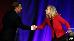 FILE - Virginia Congressman Dave Brat, R-Va., left, shakes hands with Democratic challenger Abigail Spanberger, right, after a debate at Germanna Community College in Culpeper, Virginia, Oct. 15, 2018.