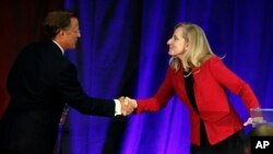 Virginia Congressman Dave Brat, R-Va., left, shakes hands with Democratic challenger Abigail Spanberger, right, after a debate at Germanna Community College in Culpeper, Virginia, Oct. 15, 2018. 