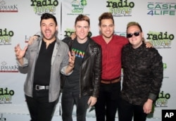 FILE - Eli Maiman, from left, Nicholas Petricca, Kevin Ray and Sean Waugaman of the band Walk the Moon pose for photographers.