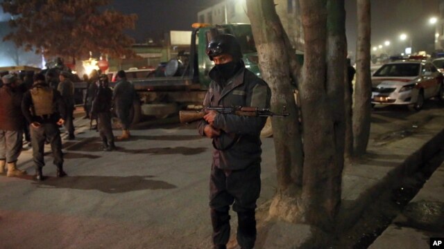 Afghan security forces stand guard near a terrorist attack site, close to the Spanish embassy, in center of Kabul, Afghanistan, Dec. 11, 2015.  