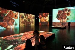 FILE - People visit the Van Gogh Alive exhibition in Tel Aviv, Feb. 2, 2013, a day before its official opening.