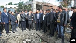 A delegation of Arab League officials visits a site to inspect damages to buildings after a car bomb attack in Damascus, Syria, December 23, 2011.