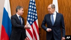 U.S. Secretary of State Antony Blinken, left, greets Russian Foreign Minister Sergey Lavrov before their meeting, in Geneva, Switzerland, Jan. 21, 2022.