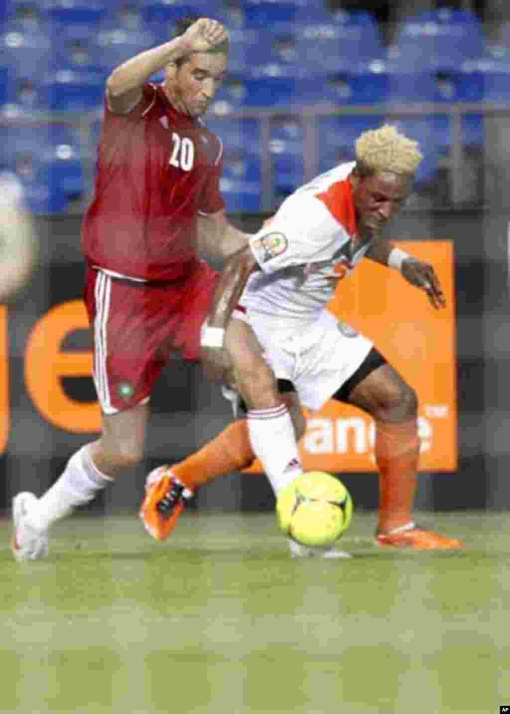 Morocco's Youssouf Hadji (20) is tackled by Niger's Jimmy Bulus during their final African Cup of Nations Group C soccer match at the Stade De L'Amitie Stadium in Libreville, Gabon January 31, 2012.