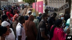 People line up to cast their ballot for Gambia's presidential elections, in Banjul, Gambia, Dec. 4, 2021. Lines of voters formed outside polling stations in the first presidential election without former dictator Yahya Jammeh as a candidate.