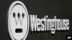 FILE - The corporate logo is on the sign marking the driveway to the Westinghouse International Headquarters in Cranberry, Pa., May 19, 2014.