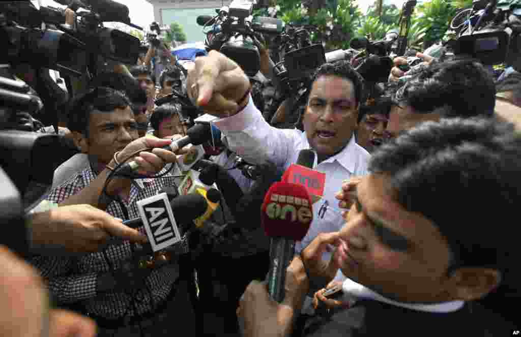 Defense lawyer A.P. Singh reacts to a protester heckling him for defending a convict in the fatal gang rape of a young woman on a New Delhi bus last year, outside a court in New Delhi, Sept. 11, 2013. 