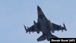 A missile-loaded Turkish Air Force warplane rises in the sky after taking off from Incirlik Air Base, in Adana, Turkey, Wednesday, July 29, 2015.