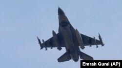 A missile-loaded Turkish Air Force warplane rises in the sky after taking off from Incirlik Air Base, in Adana, Turkey, Wednesday, July 29, 2015.