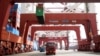 Trucks transport containers at a port in Qingdao, Shandong province, China, Apr. 8, 2018. 