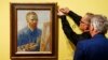 FILE - Curators hang the 1888 self-portrait of Vincent Van Gogh in Amsterdam, The Netherlands, May 1, 2013. 