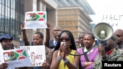 FILE - Singer Khadja Nin (C) takes part in a protest against Burundi President Pierre Nkurunziza and his bid for a third term, in Brussels, Belgium, May 23, 2015. 