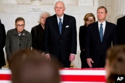 (L-R): Supreme Court Justices Ruth Bader Ginsburg, Anthony Kennedy and Chief Justice John Roberts attend a private ceremony in the Great Hall of the Supreme Court in Washington for late Justice Antonin Scalia, Feb. 19, 2016.