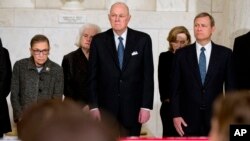 From left, Supreme Court Justices Ruth Bader Ginsburg and Anthony Kennedy, and Chief Justice John Roberts attend a private ceremony in the Great Hall of the Supreme Court in Washington for late Justice Antonin Scalia, Feb. 19, 2016.