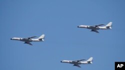 Des porte-missiles de croisière H-6K volent en formation lors d'un défilé commémorant le 70e anniversaire de la capitulation du Japon pendant la Seconde Guerre mondiale, à Beijing, le jeudi 3 septembre 2015.