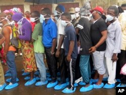 Family of victims of heavy flooding and mudslides that killed more than 300 people in Regent wait to identify their bodies at Connaught hospital morgue in Freetown, Sierra Leone, Aug. 16 , 2017.