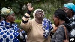 Mary Italo, center, grieves with other relatives for her son Thomas Abayo Italo, 33, who was killed in the Westgate Mall attack, as they wait to receive his body at the mortuary in Nairobi, Kenya Wednesday, Sept. 25, 2013. 