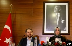 Fatma Betul Sayan Kaya, Turkey's Minister of Family Affairs, and Berat Albayrak, Energy Minister and son-in-law of President Erdogan, speak to the media at Ataturk Airport after her return to Turkey, in Istanbul, March 12, 2017.