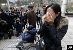 A family member of a victim of toxic humidifier disinfectants weeps during a press conference against the court's sentence in Seoul, South Korea, Jan. 6, 2017. Family members and victims wanted harsher sentences.