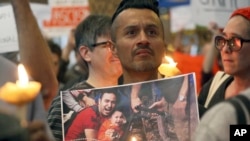 A man joins hundreds of demonstrators opposed to President Donald Trump's executive order barring U.S. entry to Muslims from certain countries, at Los Angeles International Airport, California, Jan. 28, 2017.