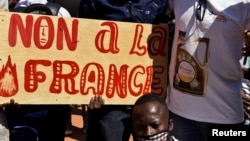 Demonstrators hold a placard that reads "No to France" during a protest calling for the departure of French forces from Burkina Faso, in the capital Ouagadougou, Nov. 16, 2021.
