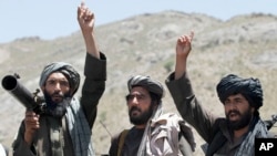 FILE - Taliban fighters react to a speech by their senior leader in the Shindand district of Herat province, Afghanistan. 