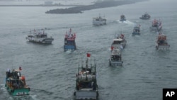 Several dozen fishing boats flying Taiwanese national flags set out from the Suao harbor, northeastern Taiwan, to the disputed islands in the East China Sea, September 24, 2012. 