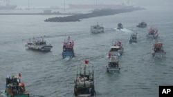 FILE - Several dozen fishing boats flying Taiwanese national flags set out from the Suao harbor, northeastern Taiwan, Sept. 24, 2012.