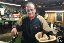 Roman Gadayev works in his Brighton Beach shoe repair shop in New York, Dec. 15, 2016. Gadayev holds a firm view on allegations that Russia meddled in the U.S. presidential election. "Simply impossible," said the Kazakhstan native.