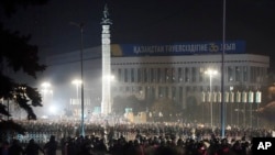 FILE - Riot police block protesters in the center of Almaty, Kazakhstan, Jan. 5, 2022.