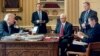 FILE - President Donald Trump, accompanied by, from second from left, Chief of Staff Reince Priebus, Vice President Mike Pence, White House press secretary Sean Spicer and National Security Adviser Michael Flynn, speaks on the phone with Russian President Vladimir Putin, Jan. 28, 2017, in the Oval Office at the White House in Washington.