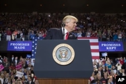 President Donald Trump pauses while speaking at a rally at the Kentucky Exposition Center in Louisville, Kentucky, March 20, 2017.