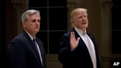 President Donald Trump, accompanied by House Majority Leader Kevin McCarthy of Calif., speaks to members of the media as they arrive for a dinner at Trump International Golf Club in in West Palm Beach, Florida, Jan. 14, 2018.