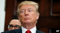 President Donald Trump listens during an event to sign an executive order on health care in the Roosevelt Room of the White House, Oct. 12, 2017, in Washington.