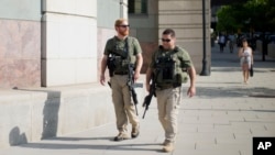 US Marshals patrol the area outside federal court in Washington, July 2, 2014, where Libyan militant Ahmed Abu Khatallah, charged in the deadly attack at the U.S. diplomatic outpost in Benghazi, is being held for a detention hearing.