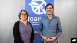 Sascha Hach, right, and Xanthe Hall of the International Campaign to Abolish Nuclear Weapons ICAN Germany, pose in their office in Berlin, Oct. 6, 2017. 