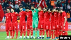 Turkey's players observe a minute of silence for the victims of the Paris attacks before their soccer match Nov. 17, 2015, against Greece in Istanbul.