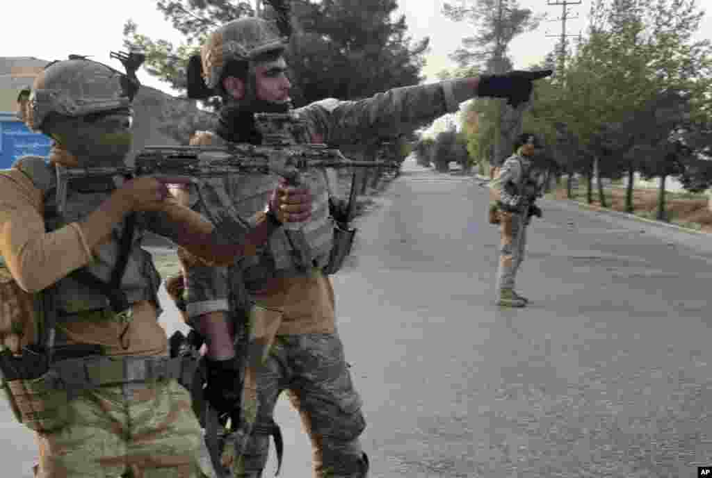 Afghan Special forces patrol a deserted street during fighting with Taliban fighters, in Lashkar Gah, Helmand province, southern Afghanistan.