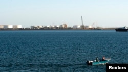 FILE - A speed boat passes by oil docks at the port of Kalantari in the city of Chabahar, 300km (186 miles) east of the Strait of Hormuz, Jan. 17, 2012. 