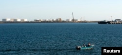 FILE - A speed boat passes by oil docks at the port of Kalantari in the city of Chabahar, 300km (186 miles) east of the Strait of Hormuz.