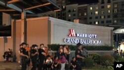 Pasukan keamanan bersenjata dan pengunjung berkumpul di luar hotel Marriot di kompleks Resorts World Manila, Filipina, 2 Juni 2017.