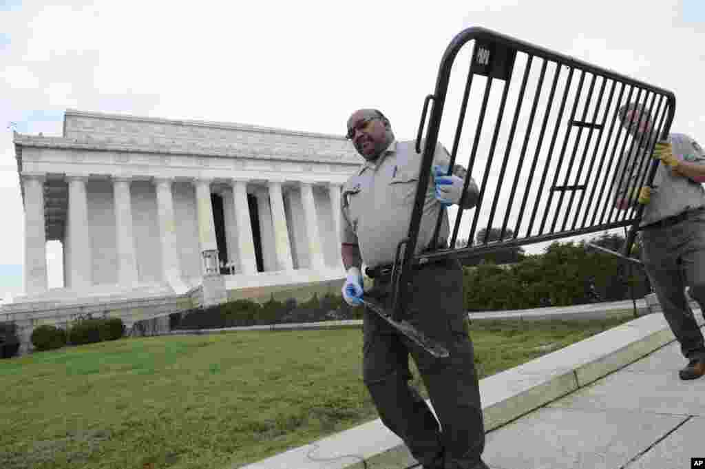 National Park Service employees remove barricades from the grounds of the Lincoln Memorial in Washington, Thursday, Oct. 17, 2013.