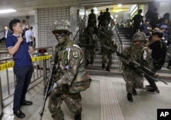 South Korean army soldiers conduct an anti-terror drill as part of Freedom Guardian exercise with the United States inside a subway station in Seoul, South Korea, Aug. 22, 2017.