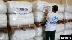 A UNHCR employee arranges aid at the Dubai International Humanitarian city in Dubai, United Arab Emirates, before shipping them to Yemen, May 14, 2015. 