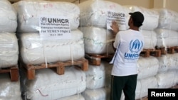 A UNHCR employee arranges aid at the Dubai International Humanitarian city in Dubai, United Arab Emirates, before shipping them to Yemen, May 14, 2015. 