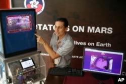 Peruvian scientist David Ramirez points to a potato plant in a simulator that produces conditions similar to those of Mars, in Lima, Peru, March 16, 2017.